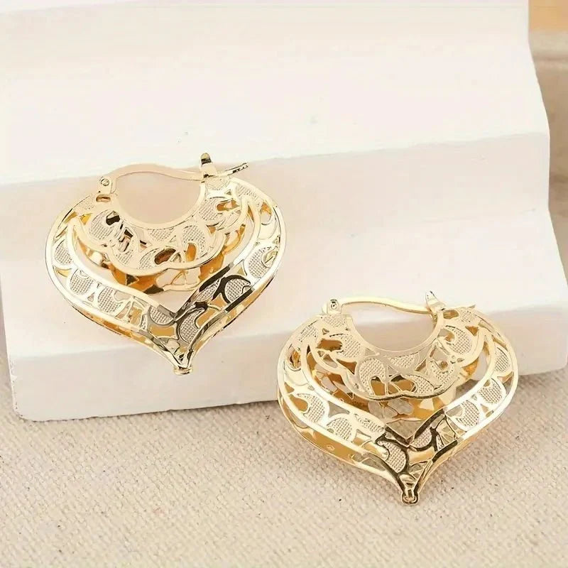 https://cdn.shopify.com/s/files/1/0820/4999/0943/files/intricate-open-heart-golden-earrings-631009.webp?v=1718191081
