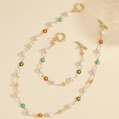 https://cdn.shopify.com/s/files/1/0820/4999/0943/files/dainty-spring-floral-pearls-bracelet-and-necklace-set-263106.webp?v=1715165103