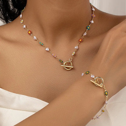 https://cdn.shopify.com/s/files/1/0820/4999/0943/files/dainty-spring-floral-pearls-bracelet-and-necklace-set-342466.webp?v=1715165103