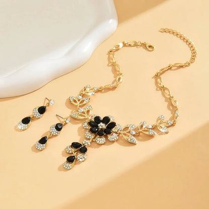 https://cdn.shopify.com/s/files/1/0820/4999/0943/files/floral-black-and-gold-diamond-necklace-and-earring-set-258782.webp?v=1718191087
