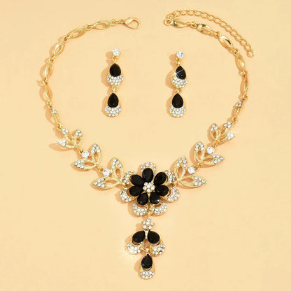 https://cdn.shopify.com/s/files/1/0820/4999/0943/files/floral-black-and-gold-diamond-necklace-and-earring-set-883240.webp?v=1718191087