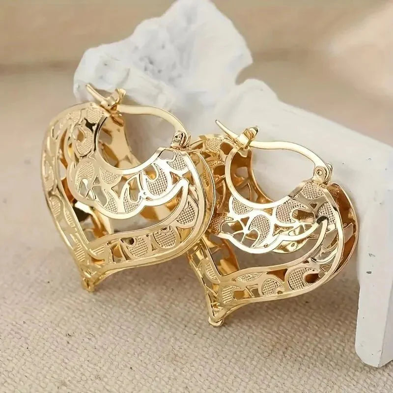 https://cdn.shopify.com/s/files/1/0820/4999/0943/files/intricate-open-heart-golden-earrings-444491.webp?v=1762198309