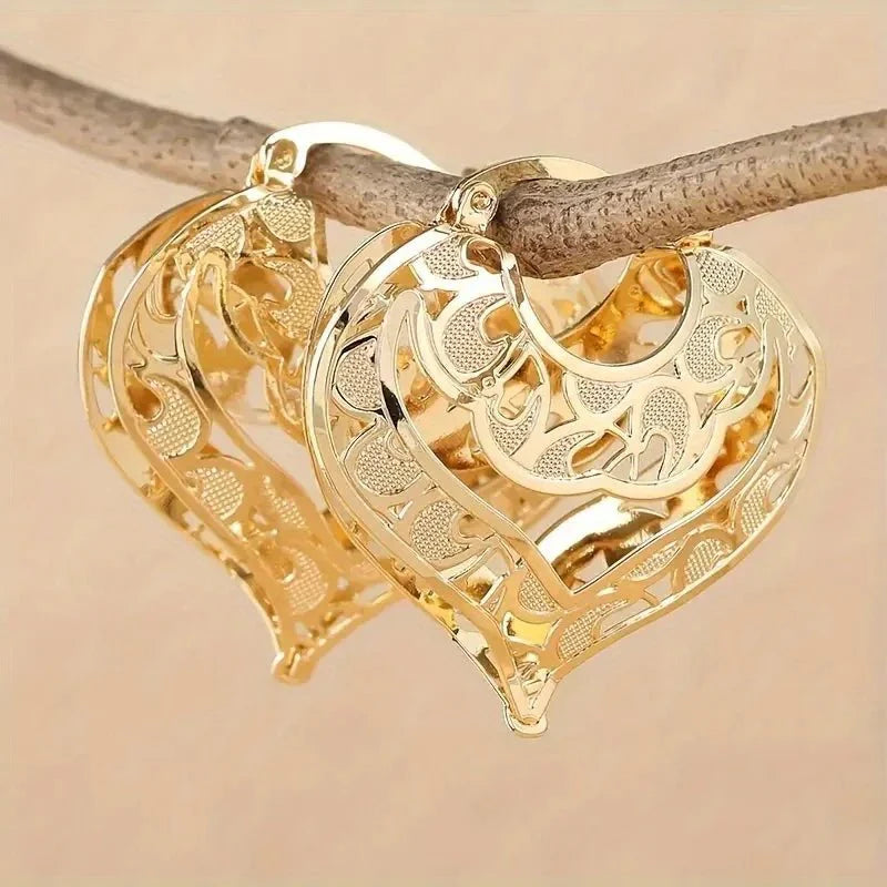 https://cdn.shopify.com/s/files/1/0820/4999/0943/files/intricate-open-heart-golden-earrings-809820.webp?v=1718191081