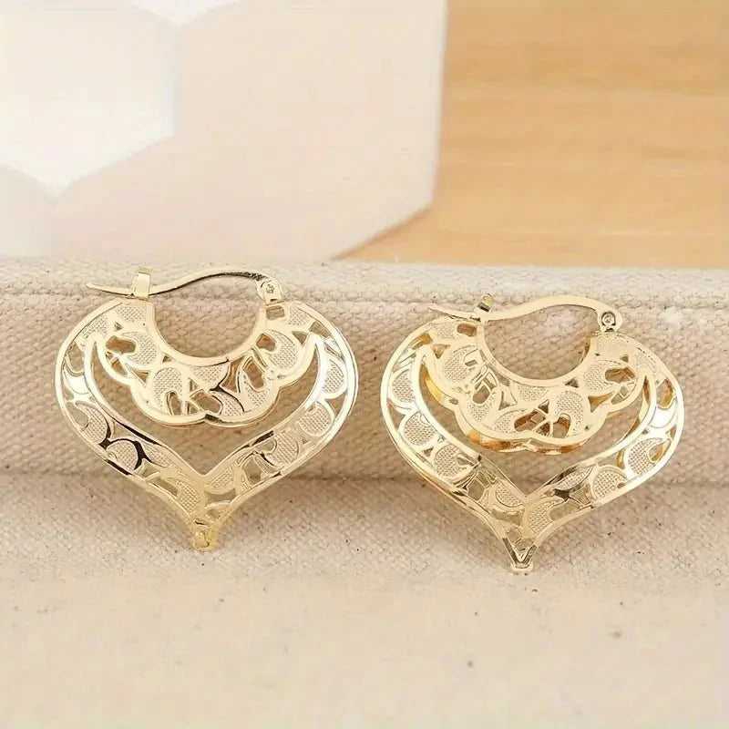 https://cdn.shopify.com/s/files/1/0820/4999/0943/files/intricate-open-heart-golden-earrings-873620.webp?v=1718191081