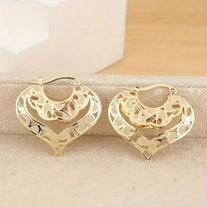 https://cdn.shopify.com/s/files/1/0820/4999/0943/files/intricate-open-heart-golden-earrings-873620.webp?v=1718191081